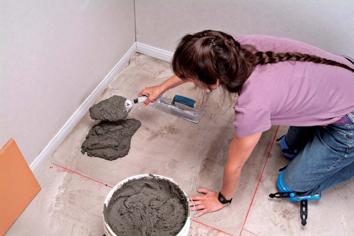 Scoop a large amount of thinset onto the floor with a trowel.