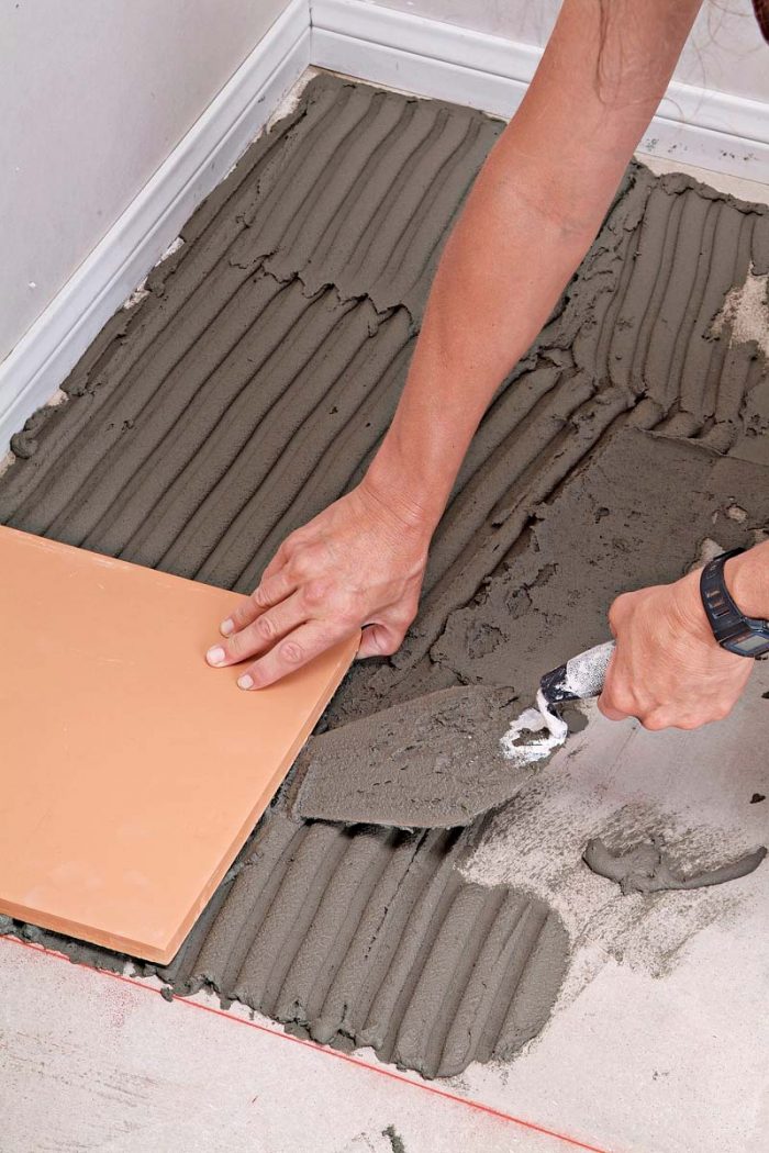 Use a trowel or margin trowel to lift tiles that aren’t well seated in the thinset.