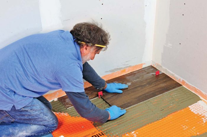 Lay the first tile, add leveling spacers, and then place the next tile.