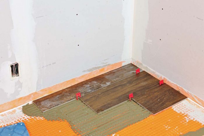 Cut your third row tile, being careful not to exceed 33% overlap. Add spacers and set the tile.
