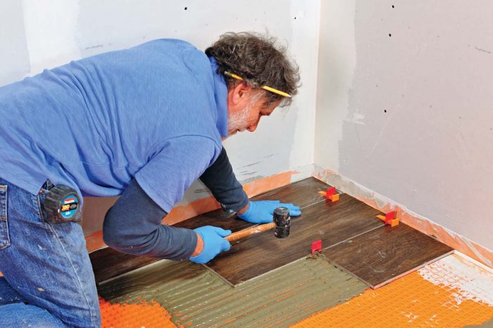 Use a mallet to beat the tile in place.