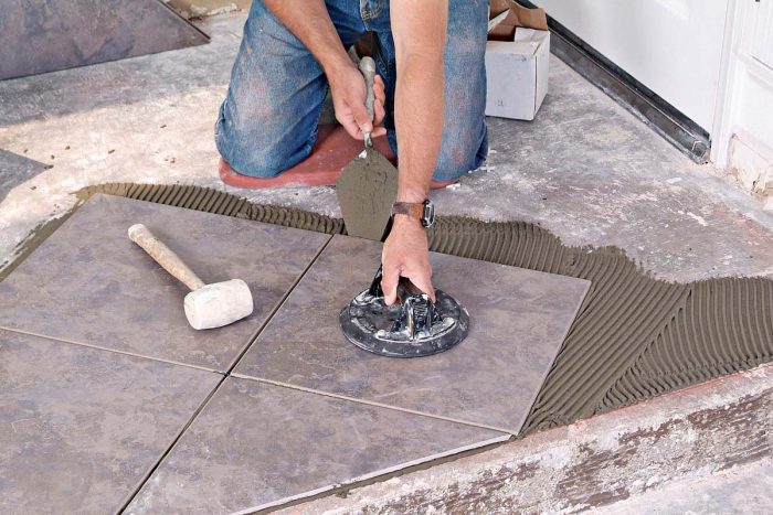 A margin trowel and suction lifter make it easy to lift tiles that need a bit more thinset under them.