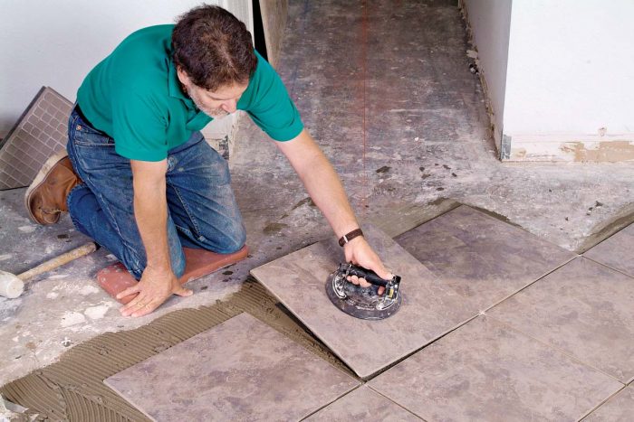 A suction lifter makes it easy to position large, heavy tiles or to lift tiles that need to be adjusted.