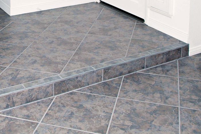 Careful layout ensures that the rows of diagonally set tile and the grout joints line up all the way across the floor
