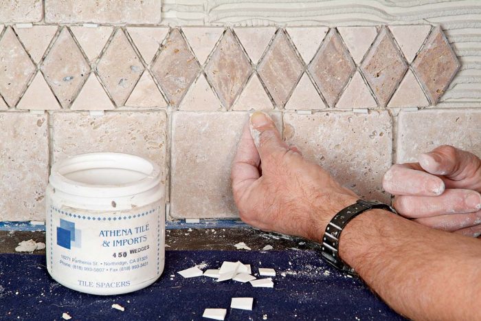 Insert wedges to help maintain an even grout joint.