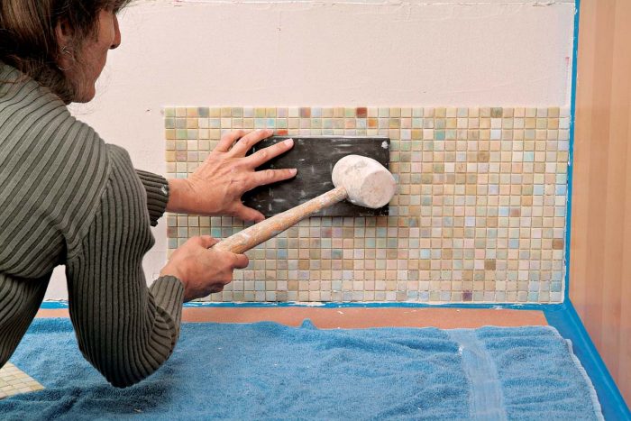 Strike your beater block gently and evenly to embed the mosaic tiles in place.