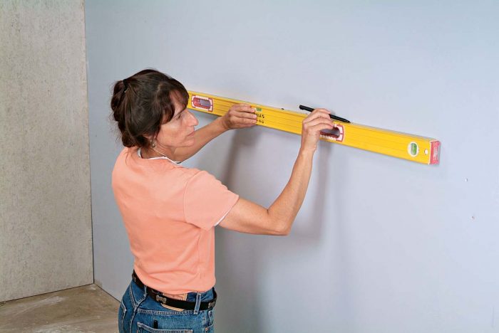 Use a level to make your mark into a continuous line for the new wainscoting.