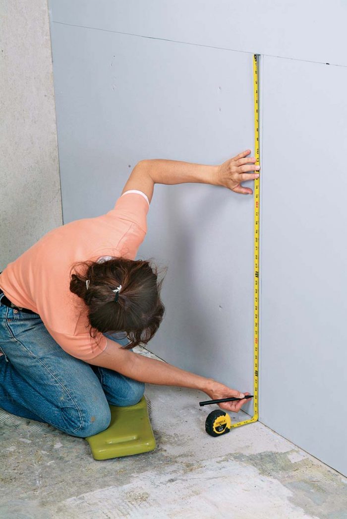 Measure down from the top mark of your wainscoting to the grout joint above the bottom cut tile.
