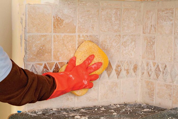 Wipe diagonally across tiles with a well-squeezed sponge to remove excess grout.