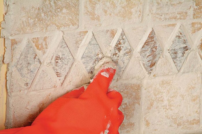 MCheck for areas of missing grout, especially around relief tiles. Fill with a fingertip full of grout.