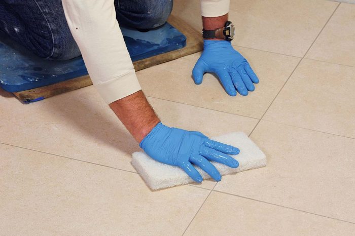 Agitate the surface of the tile with a white scrub pad and it will loosen any residual grout. Use care to prevent gouging your shaped grout joints.