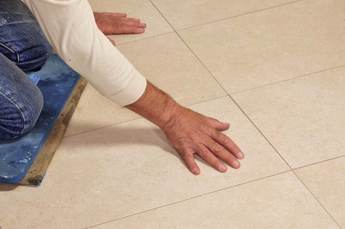 Feel the face of the tiles with your bare hands to locate any grout residue. If you feel any stickiness or granules, wipe them off.