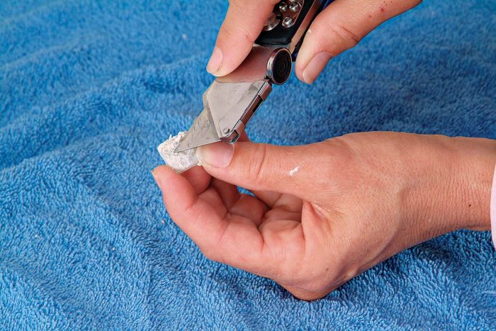 Clean the tile by scraping off the thinset with a utility knife.