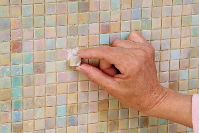 Reset the tile back in its place. Remember its location when you start to grout.