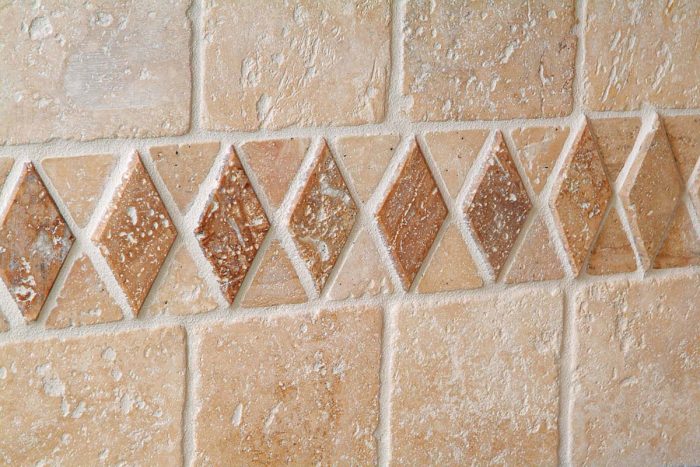 For natural stone that’s partially filled, the tile surface should appear clean. Grout joints will be shaped and full but should not appear wet.