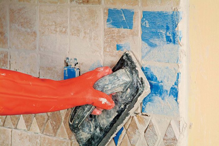 Grout over taped areas with care.