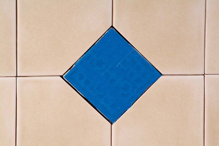 Taped embossed tile will remain free from grout when the area is grouted.