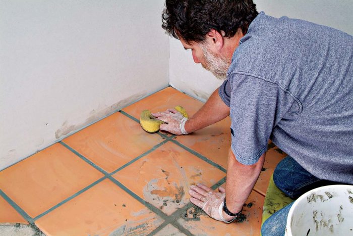 Wipe and shape the grout joints with a sponge.