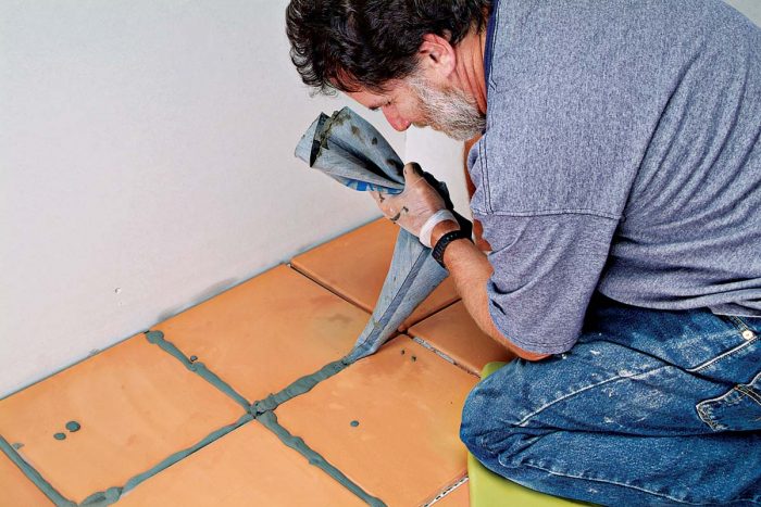 Strong arms are handy for squeezing grout from the bag.