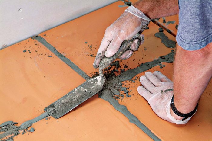Remove any excess grout material with the margin trowel.