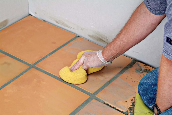 Clean the faces of the tiles without disturbing the grout joints. Clean as well as you can so that final cleanup will be minimal.
