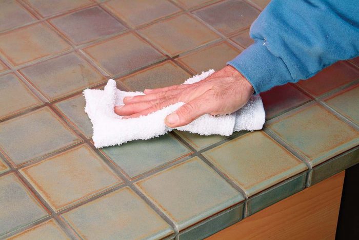 Sealer will penetrate through the grout. Wipe any excess sealer from the face of the tile.