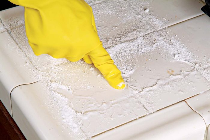 Rub the moist cleanser paste into the grout joints and let it do its work for about 5 minutes.