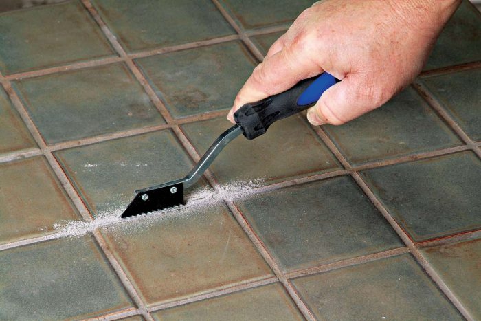 A hand-held carbide grout saw can be used to remove grout around a cracked or chipped tile.