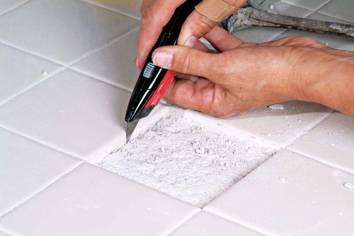 Use a razor knife to remove any remaining grout with caution. The cleaner the area, the easier it will be to fit the new tile.