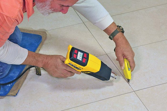 To replace a tile grouted with epoxy grout, you’ll first need to soften the grout with a heat gun. It can then be scraped out with a utility knife.