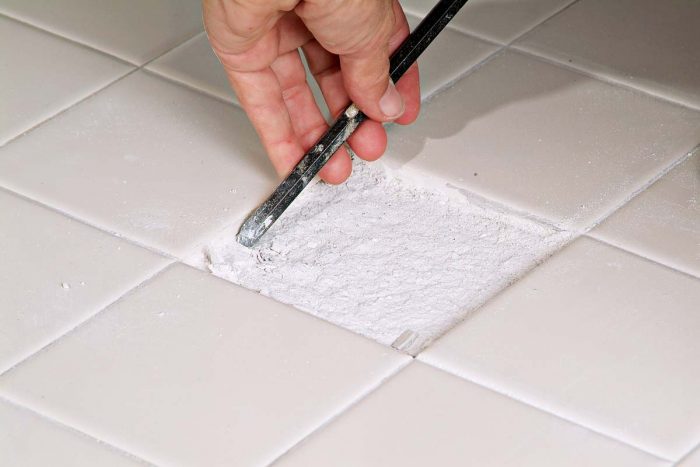 Use a chisel to remove small chunks of thinset but be careful when you do. It is very easy to chip another tile.