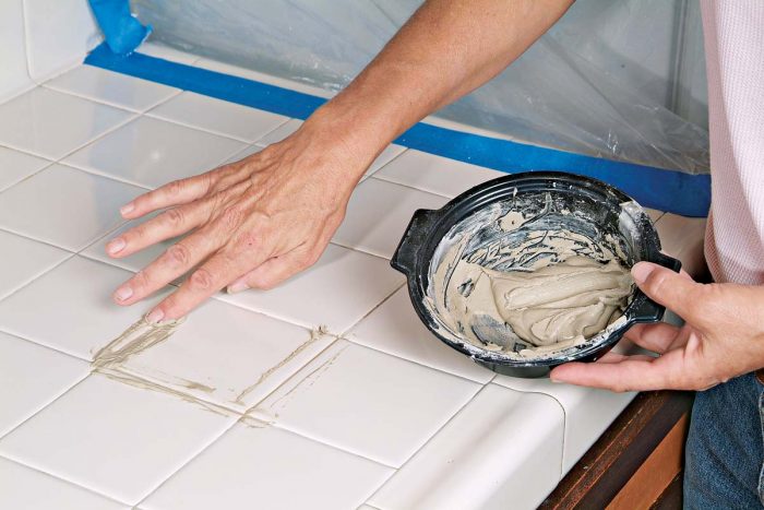 Work the grout into the joints with your finger.