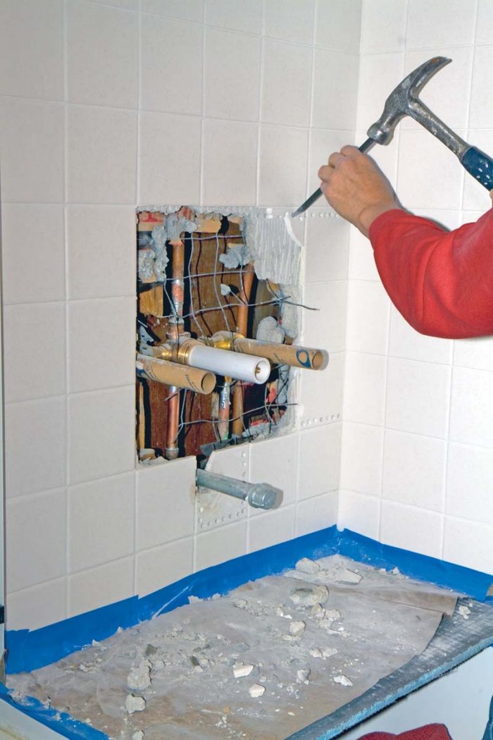 Use a hammer and chisel with care to remove the remaining tiles and mortar bed for the repair.