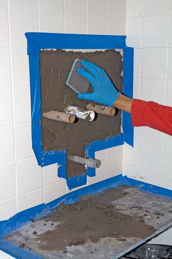 Use a scrap piece of board or other material to smooth out the mortar.