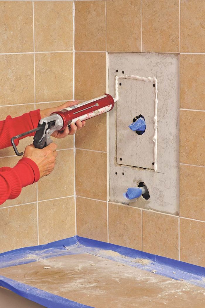 Force caulk into the gaps, smooth even with the surface, and allow to dry.