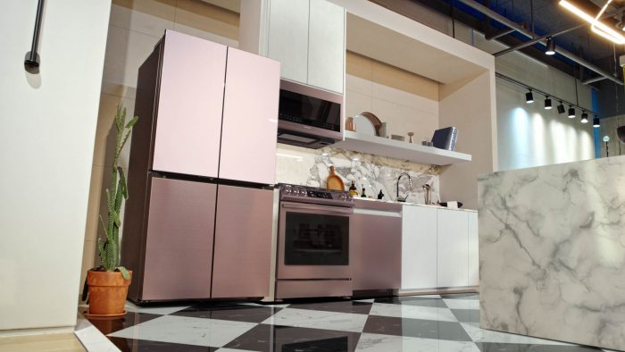 Pink refrigerator in a kitchen with a black and white checkered floor