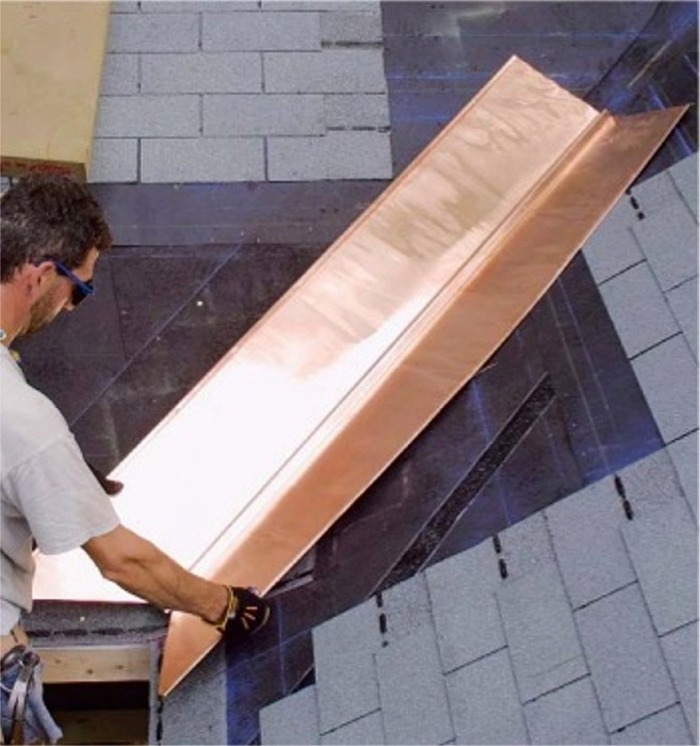 A 'W'-shaped copper sheet is placed in the center of a roof valley.