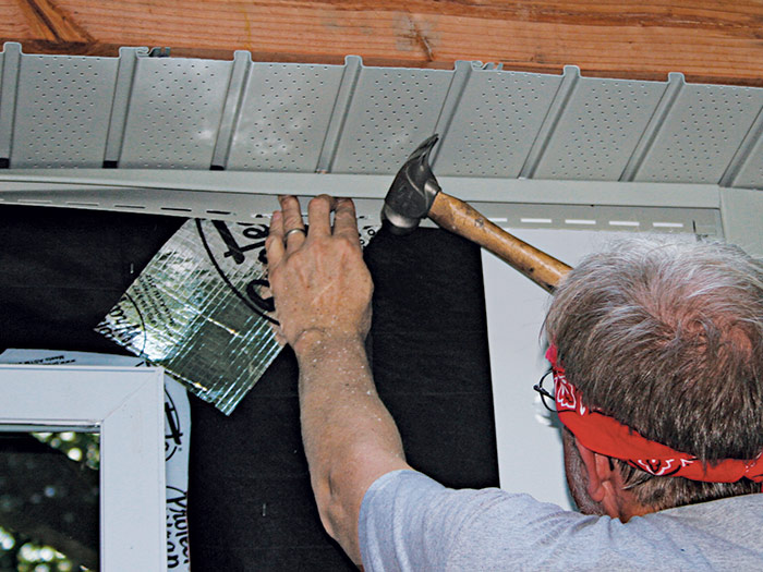 Nail J-channel directly below the soffit 