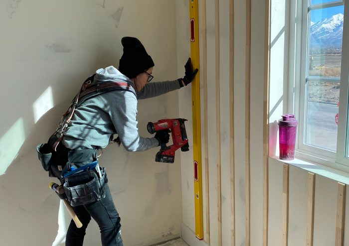 woman installing interior board-and-batten walls