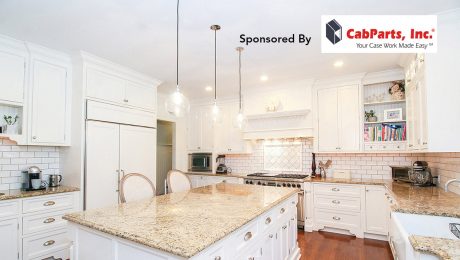 Image of a large white kitchen with an island and many cabinets