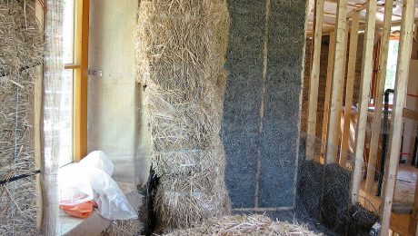 A photo of the inside of a straw-bale home under construction