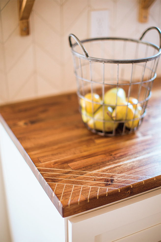 Close up of a wood countertop with a basket of fruit