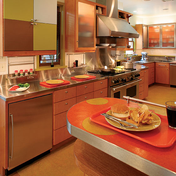 An orange kitchen with steel countertops