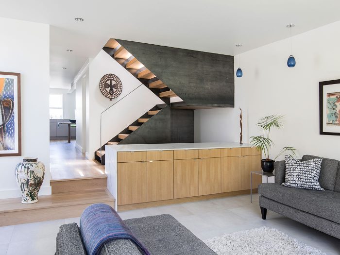The living room of a floor with a staircase