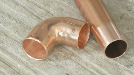 A piece of straight and curbed copper tubing