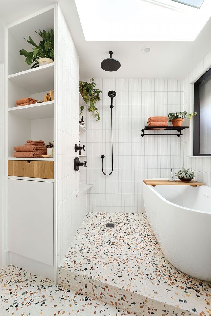 Diagonal bathroom showing linen shelves, shower, bathtub, and skylights