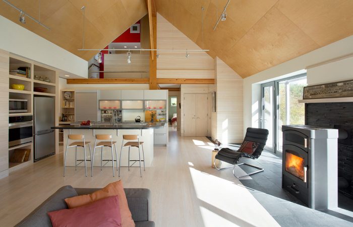 A view of the kitchen from the living room with high ceilings