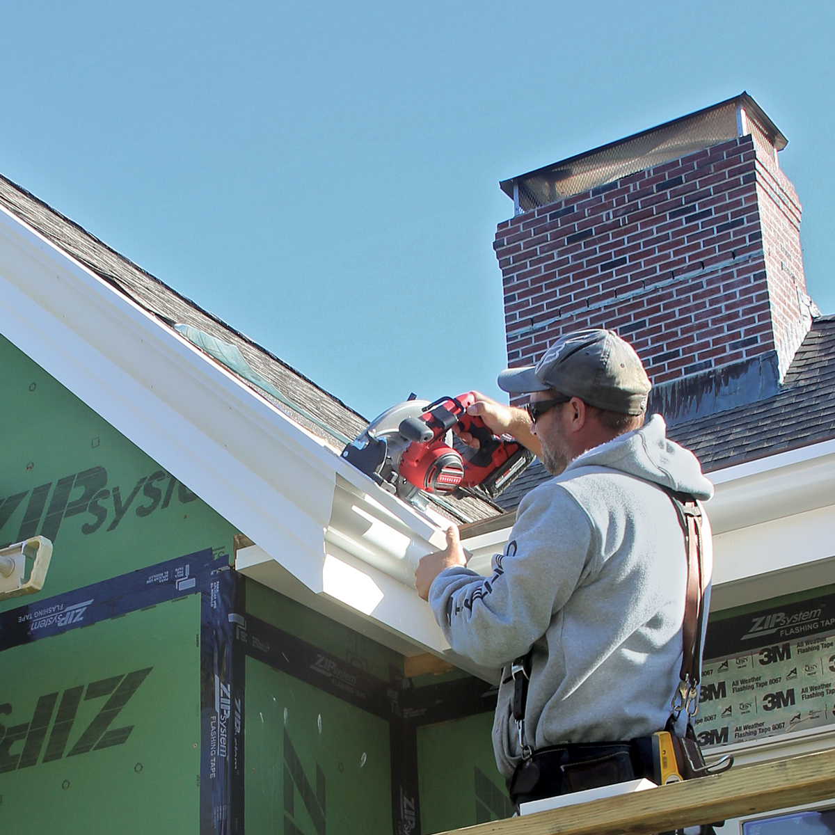 Trim the top. The trimboard that covers the rake’s projection is run long initially and trimmed on the roof.