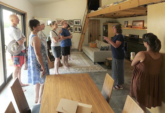 People gathered in the living area of the net-zero home