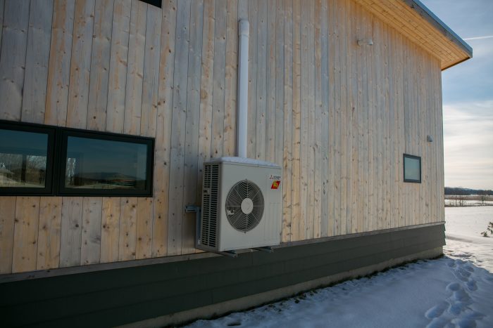 Mitsubishi heat pump on the outside of a home